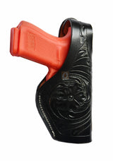 Black leather holster with thumb retention and floral tooling – right-handed gun holster designed for Glock 17, Glock 19, S&W, and Ruger. Stylish and secure leather holster for everyday carry.
